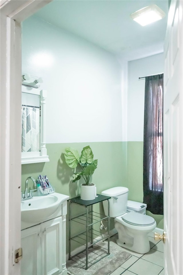 bathroom featuring tile patterned floors, vanity, and toilet