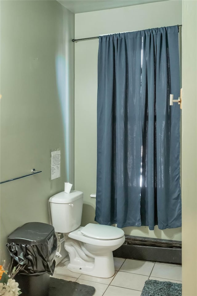 bathroom featuring tile patterned floors, a shower with curtain, and toilet