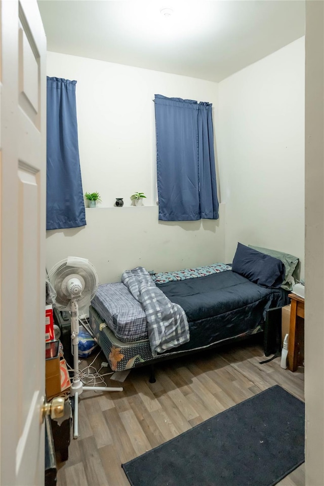 bedroom with hardwood / wood-style floors