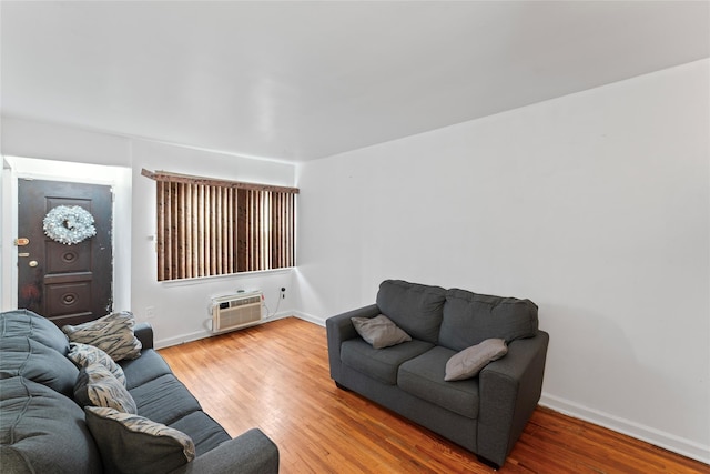 living room with a wall mounted air conditioner and wood-type flooring