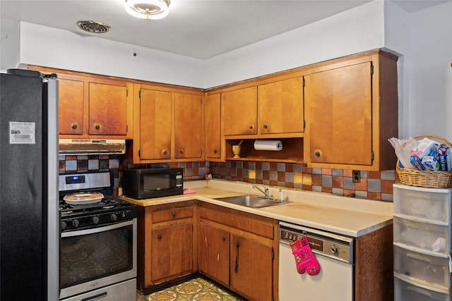 kitchen with black appliances, sink, and tasteful backsplash