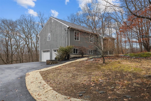 view of side of home featuring a garage