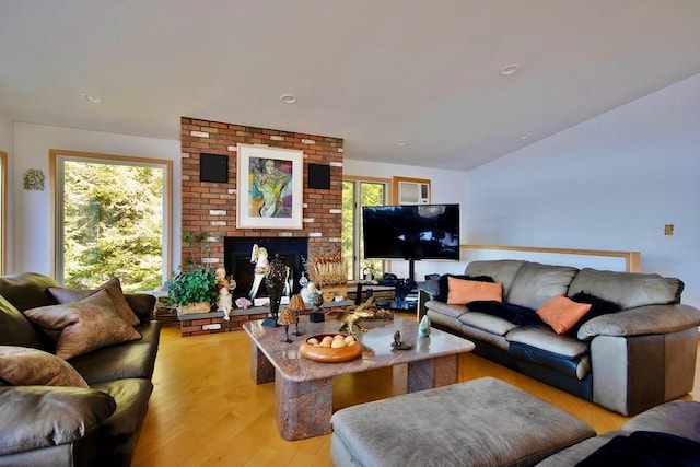 181 Starlight Rd, Monticello, NY 12701 - living area featuring a fireplace, light wood-type flooring, and lofted ceiling
