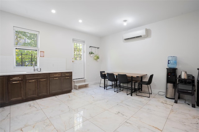 dining area featuring sink and a wall unit AC