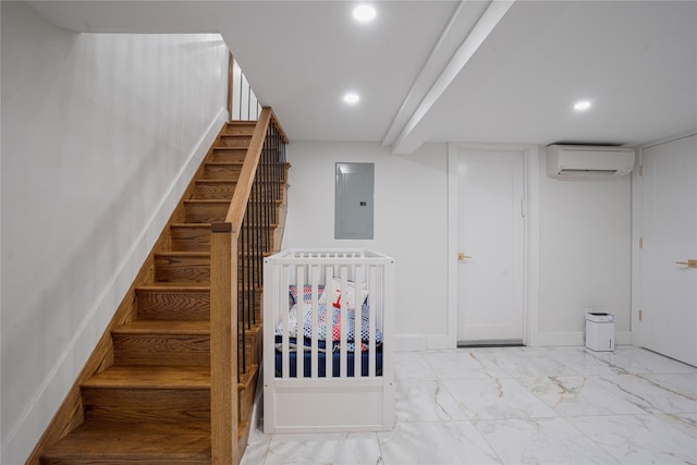 stairway with a wall unit AC and electric panel