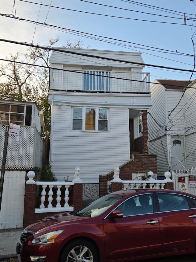 view of front of house featuring a balcony