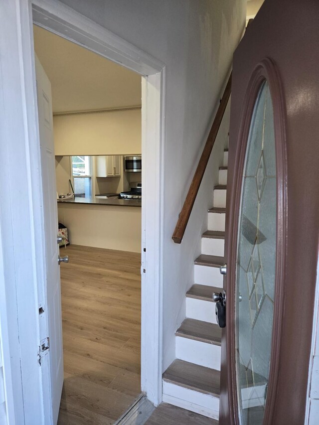 stairway featuring hardwood / wood-style floors