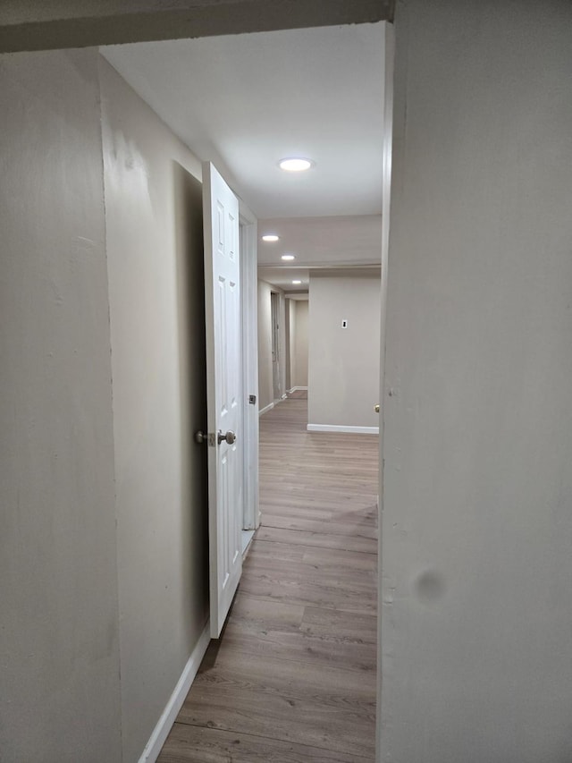 hall with light hardwood / wood-style flooring