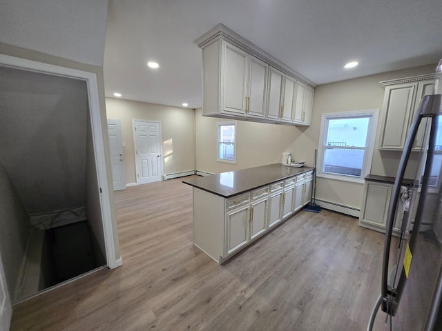 kitchen featuring light hardwood / wood-style floors, kitchen peninsula, and a baseboard radiator