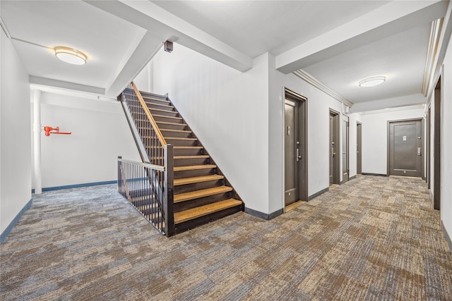 hall with dark carpet and crown molding