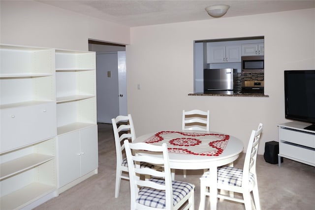 view of carpeted dining area