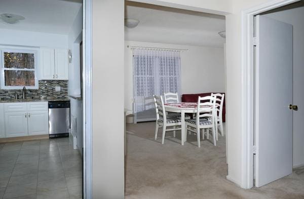 carpeted dining space with sink