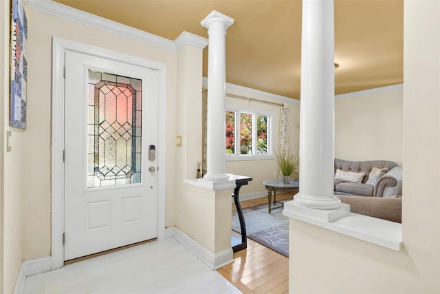 entryway with decorative columns, light hardwood / wood-style flooring, and ornamental molding