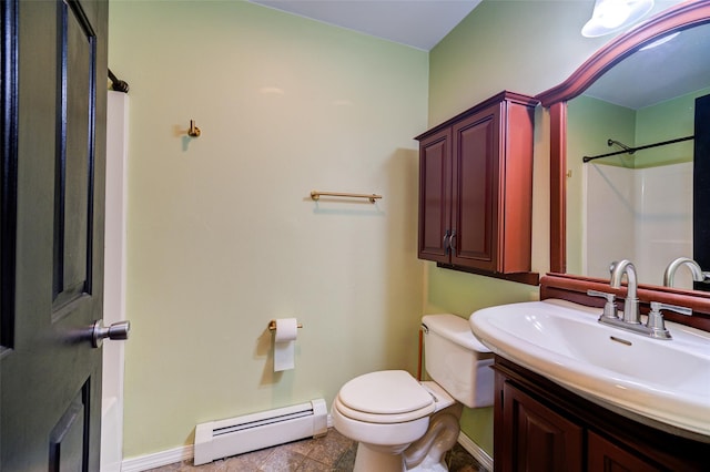 bathroom with vanity, a shower, tile patterned flooring, toilet, and a baseboard radiator