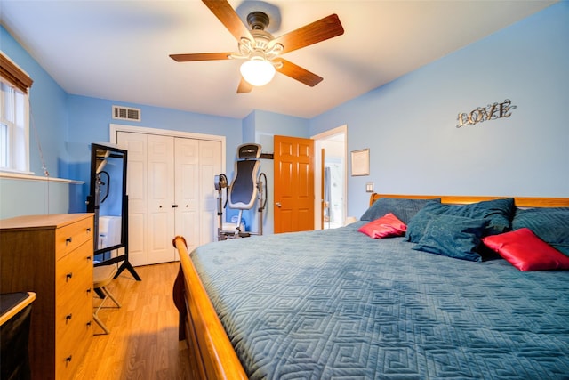 bedroom featuring hardwood / wood-style floors, a closet, and ceiling fan