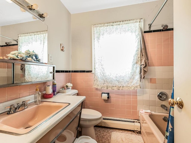 full bathroom with a baseboard radiator, tiled shower / bath combo, toilet, vanity, and tile walls