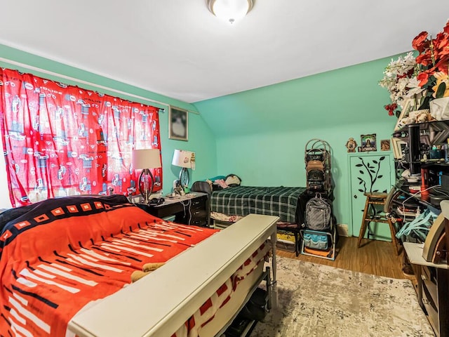 bedroom with wood-type flooring and lofted ceiling