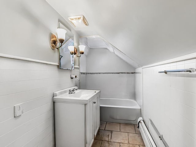 bathroom with vanity, lofted ceiling, tile patterned flooring, baseboard heating, and a tub