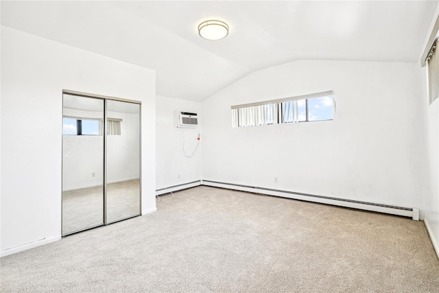 unfurnished bedroom featuring carpet flooring, vaulted ceiling, a closet, and multiple windows