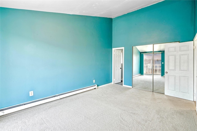 unfurnished bedroom with a baseboard radiator, a closet, and light colored carpet