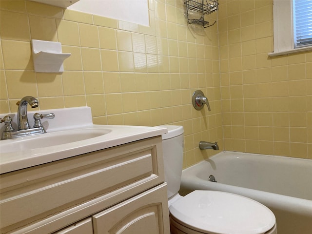 full bathroom featuring toilet, vanity, and tiled shower / bath combo