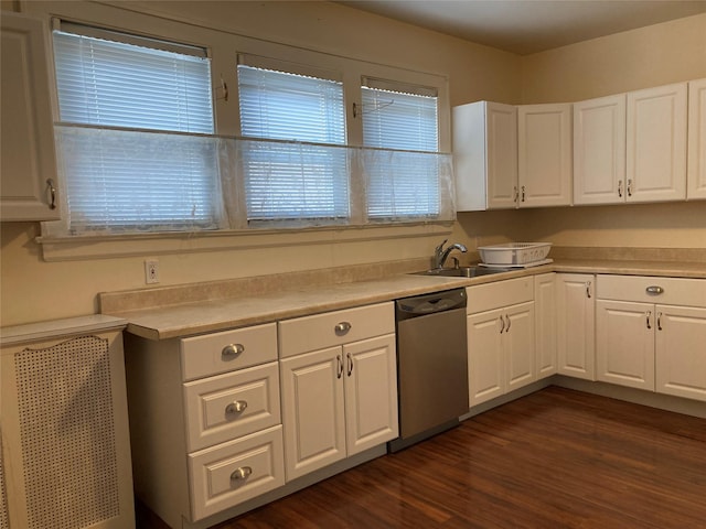 kitchen with white cabinets, stainless steel dishwasher, dark hardwood / wood-style flooring, and sink