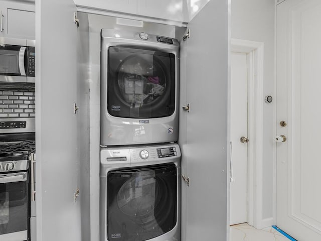 laundry room with stacked washing maching and dryer