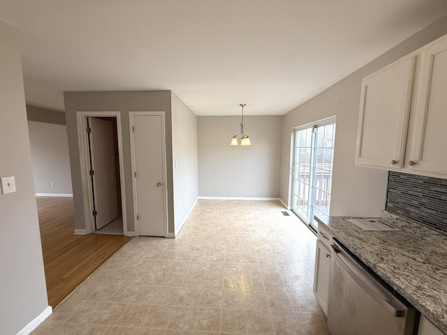 unfurnished dining area with light wood-type flooring and an inviting chandelier