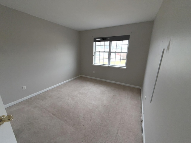 unfurnished room with light colored carpet