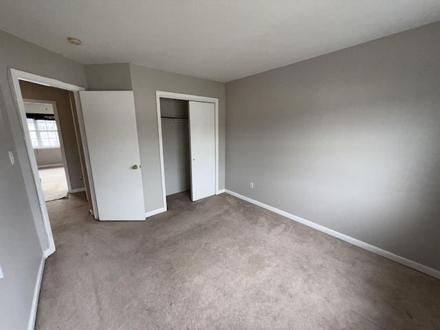 unfurnished bedroom with a closet and carpet