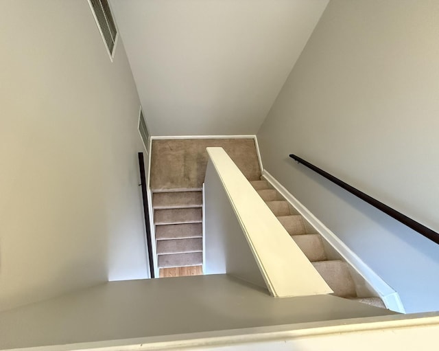 stairway with lofted ceiling