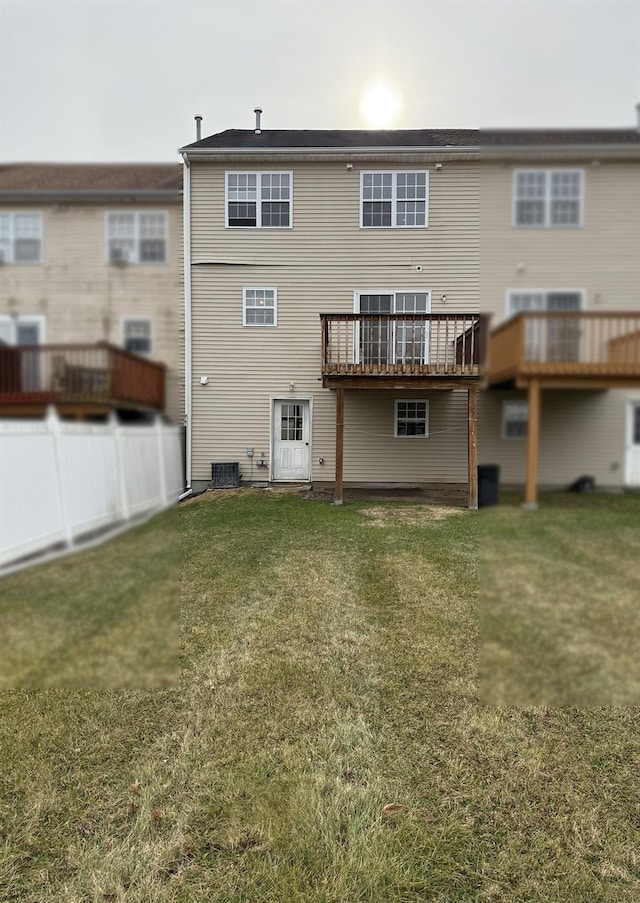 back of property with central AC unit and a yard