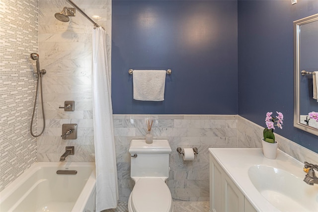 bathroom featuring a wainscoted wall, tile walls, shower / bath combination with curtain, toilet, and a sink