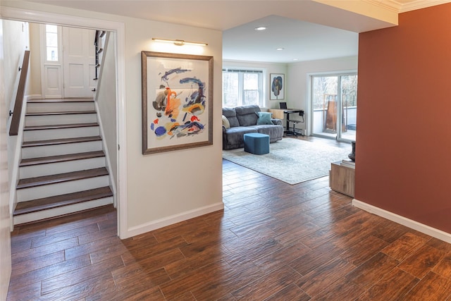 corridor featuring recessed lighting, dark wood finished floors, baseboards, and stairs