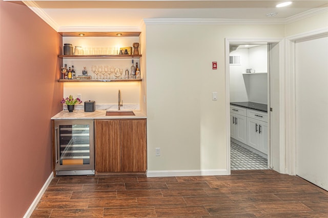 bar with dark wood-style floors, crown molding, wine cooler, and indoor wet bar