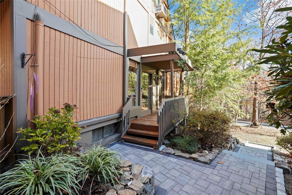 view of exterior entry with a wooden deck