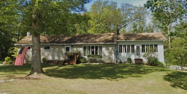 rear view of property featuring a yard