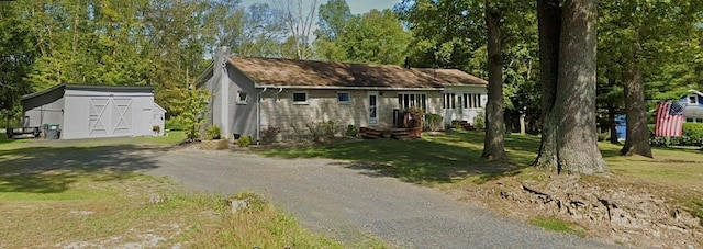 view of front of property with a front yard and a storage unit