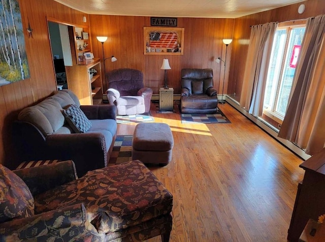 living room with wood walls, a baseboard radiator, and wood-type flooring