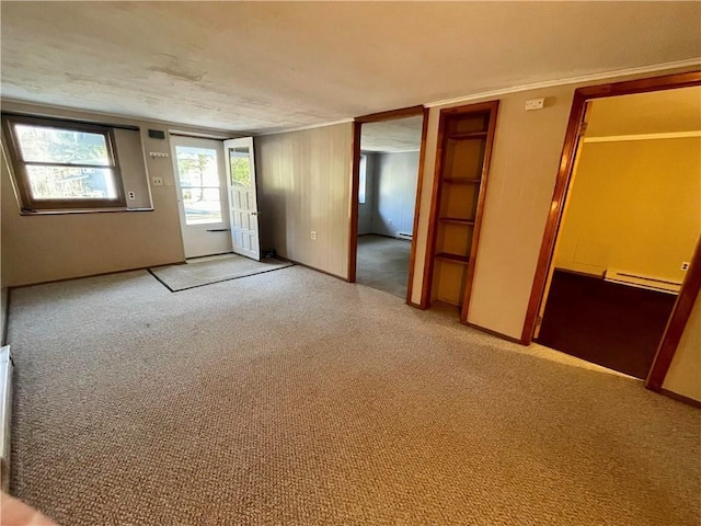 carpeted empty room featuring baseboard heating