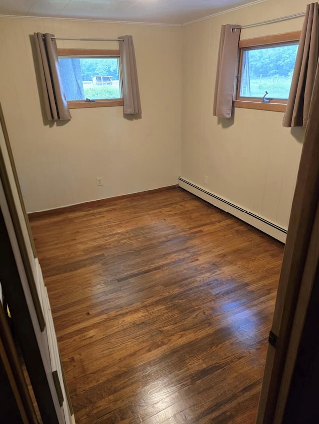 7 Red Top Rd, Wallkill, NY 12589 - empty room with a baseboard heating unit, plenty of natural light, dark wood-type flooring, and ornamental molding