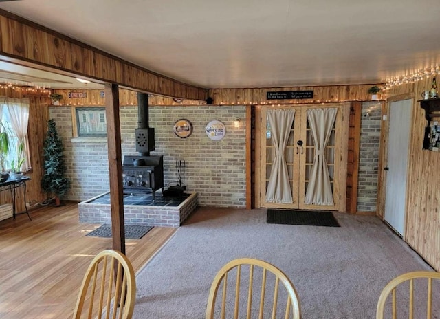 7 Red Top Rd, Wallkill, NY 12589 - foyer entrance featuring brick wall, a wood stove, and wood walls