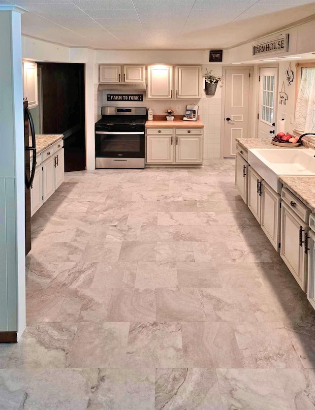 7 Red Top Rd, Wallkill, NY 12589 - kitchen with stainless steel range with gas stovetop, light countertops, light marble finish flooring, a sink, and cream cabinetry