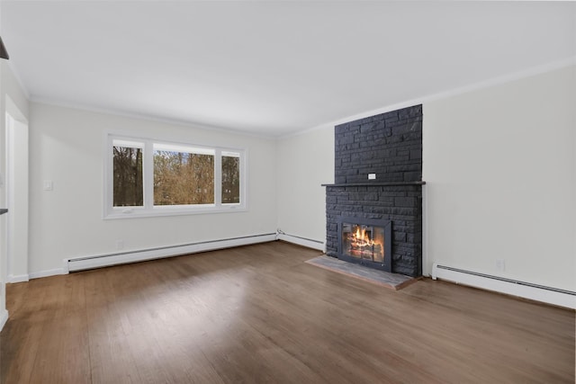 unfurnished living room with a fireplace, wood-type flooring, a baseboard radiator, and ornamental molding