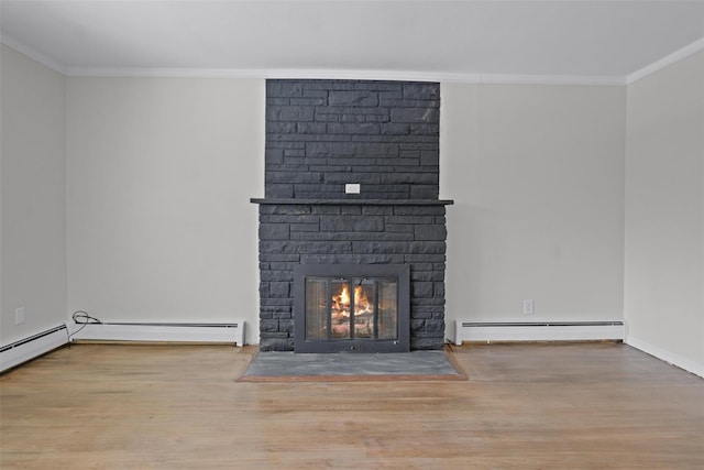 details featuring hardwood / wood-style flooring, crown molding, a fireplace, and a baseboard heating unit