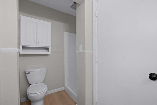 bathroom featuring hardwood / wood-style floors and toilet