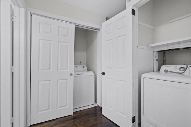 laundry area featuring washer and clothes dryer and dark wood-type flooring