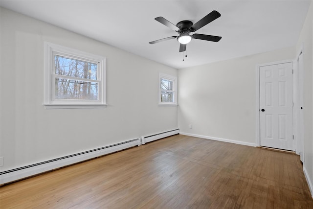 unfurnished room with ceiling fan, wood-type flooring, and a baseboard radiator