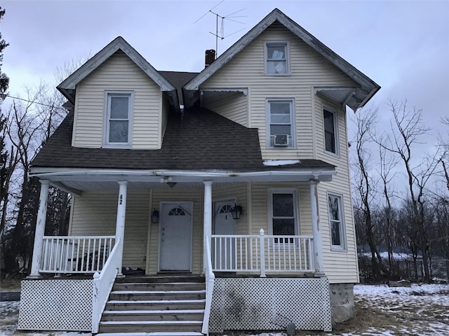 view of front facade featuring a porch and cooling unit