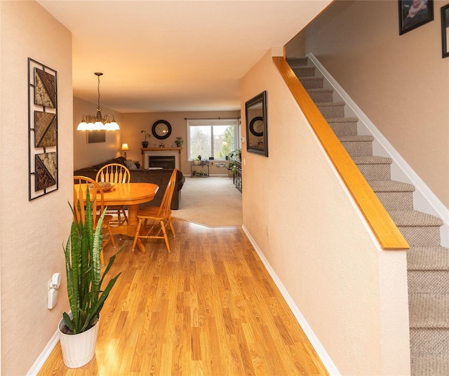 interior space featuring hardwood / wood-style flooring and an inviting chandelier